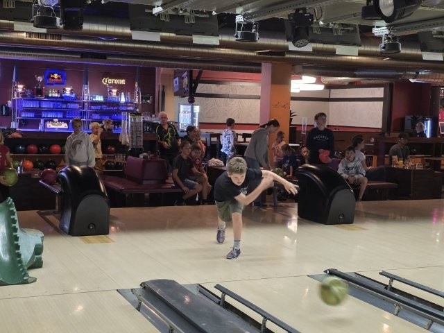 Das Bild zeigt einen Jungen beim Bowlen.